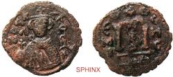 World Coins - 338HC6Z) Arab-Byzantine; Umayyad Caliphate. temp. 'Abd al-Malik ibn Marwan. AH 65-86 / AD 685-705. AE Fals. 3.61 grms, 23 mm; Imperial bust type (Type VII). Hims (Emesa) mint. Stru