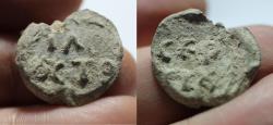 Ancient Coins - Byzantine. 6th-7th century AD.  Lead bulla (22mm, 5.98 g).  Two line legend: IΛ / OYCTO / Two line legend: CEP / CIOY.