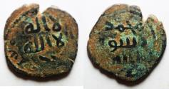 World Coins - Overstruck on a Byzantine or Arab-Byzantine: ISLAMIC. Umayyad Caliphate. Uncertain period (post-reform), AH 77-132 / AD 697-750. AE fals (21mm, 4.21g). Uncertain mint.