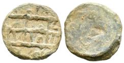 World Coins - CRONOLOGÍA INCIERTA. Amuleto monetiforme diminuto. (Pb. 1,11g/11mm). Siglo incierto. Anv: Tres líneas de escritura cúfica lineal. No tiene rastros de anillos de sujeción. Tal vez