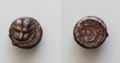 Ancient Coins - Bruttium, Rhegion Æ 9mm. 1gr. c. 425-410 BC. Facing lion's mask / Stern of galley to left, RH above; all within wreath.