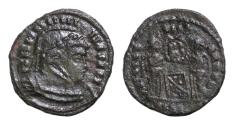 Ancient Coins - Barbaric issue, imitating Constantine I, c. 4th-5th century. Æ (18mm, 2.68g, ). Laureate, helmeted and cuirassed bust r.  Two victories standing facing one another, holding shield