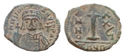 Ancient Coins - Justinian I. 527-565. Æ decanummium 20 mm, 4.2g,  Antioch mint, year 24 = 550/551. D N IVSTINIANVS PP AVG, helmeted and cuirassed bust facing, holding globus cruciger and shield