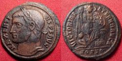 Ancient Coins - MAXENTIUS AE half follis. Ostia, 309-312 AD. VICTORIA AETERNA AVG N, Victory inscribing shield, captive at her feet. Rare.